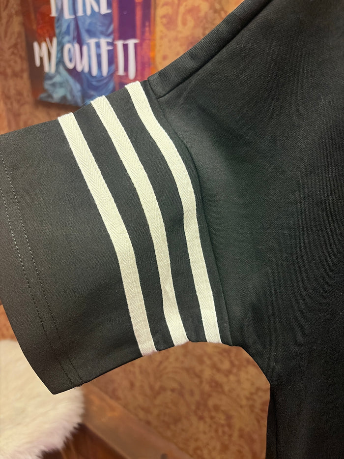 Entro sailor top featuring classic navy and white stripes, long sleeves, and a nautical-inspired design.