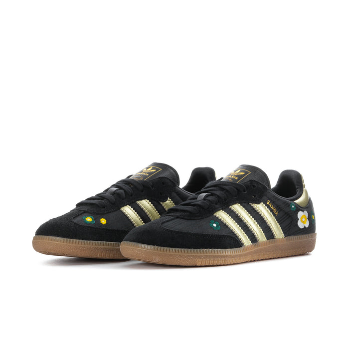 Pair of women’s black Samba sneakers with gold stripes, daisy and floral details