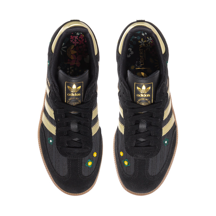 Women’s black Samba sneakers, gold stripe uppers, lace-up front, branded tongue