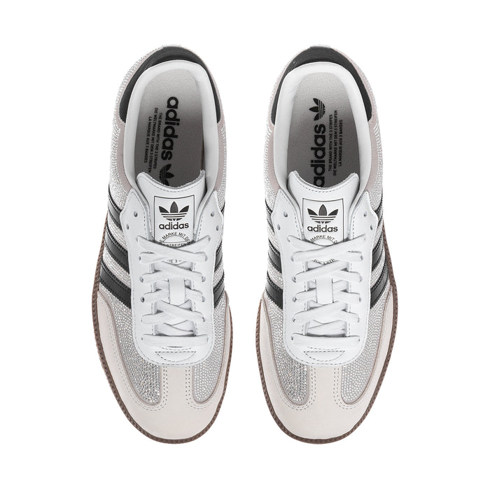 White and silver glitter sneakers with lace-up front and adidas logo on tongue