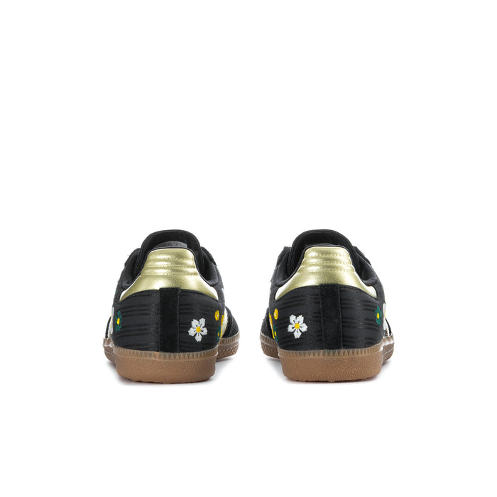 Women’s black Samba sneakers with gold heel accents, floral side patches, gum sole