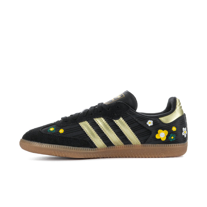 Women’s black Samba sneakers with gold stripes and small daisy floral appliques