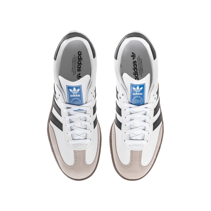 Pair of Samba OG youth sneakers in white with black stripes, brown gum soles