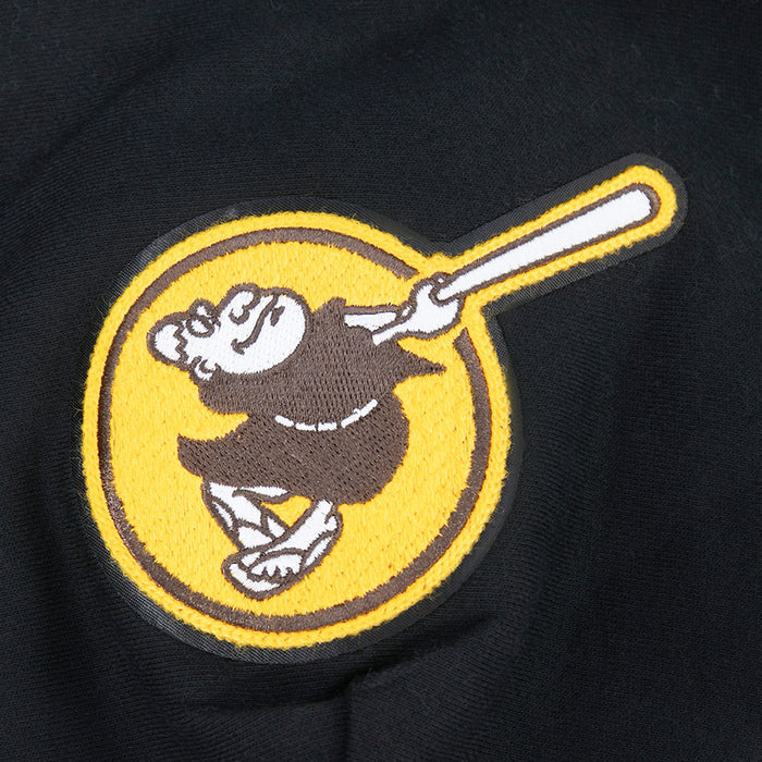 Close-up: circular Padres logo patch with baseball player graphic on black hoodie
