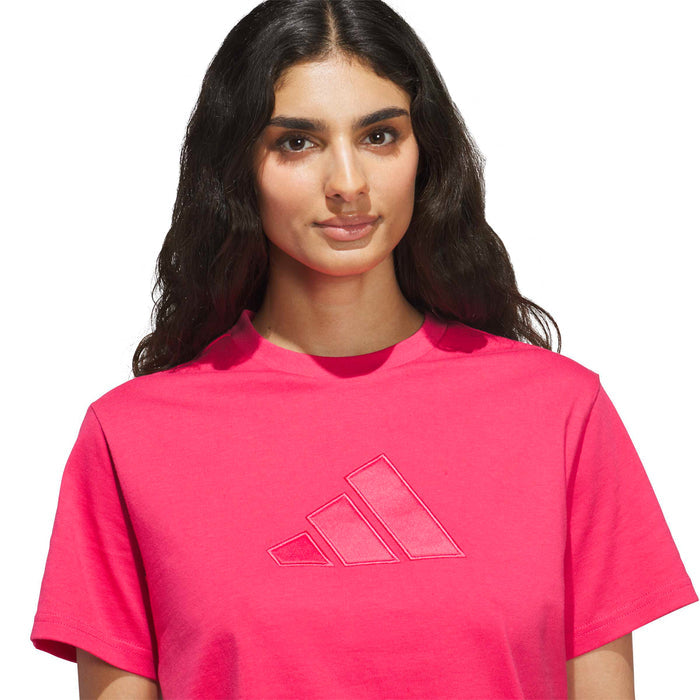 Women's satin tee close-up in power pink with embossed three-stripe logo