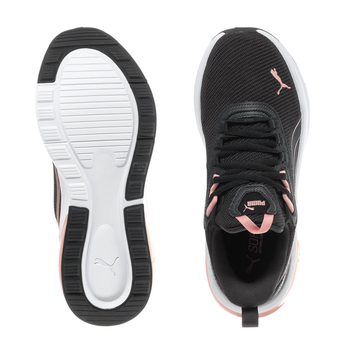 Women's black sneaker outsoles, pink heel tab, lace-up, white tread and dark outsole.
