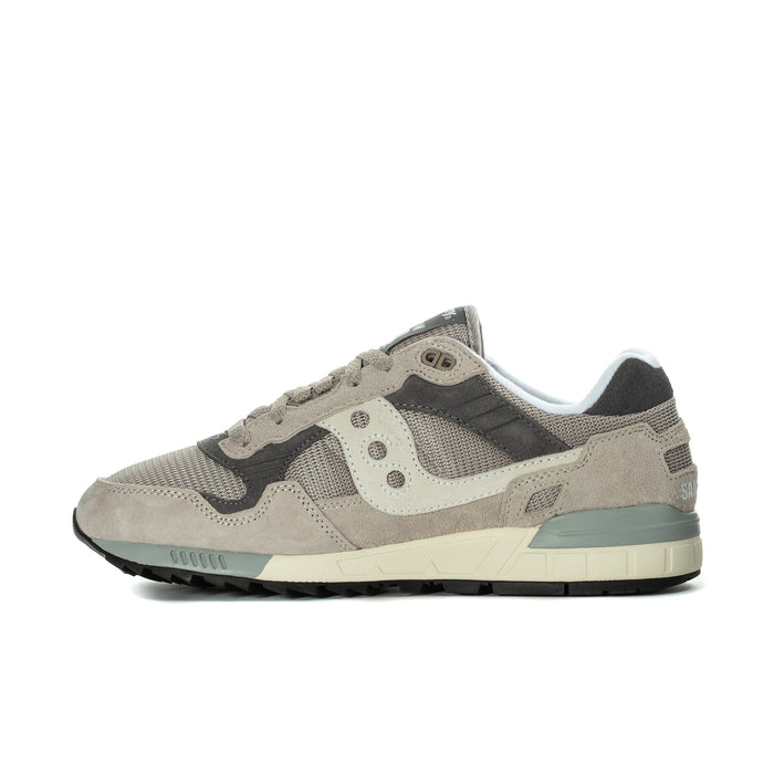 Men's Saucony sneakers, side profile in beige with dark gray panels and teal sole