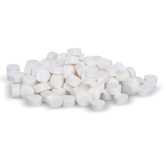 White pills are piled on a black background.