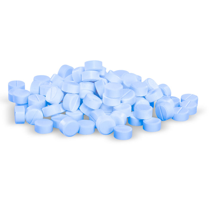 Light blue pills are piled on a white background.