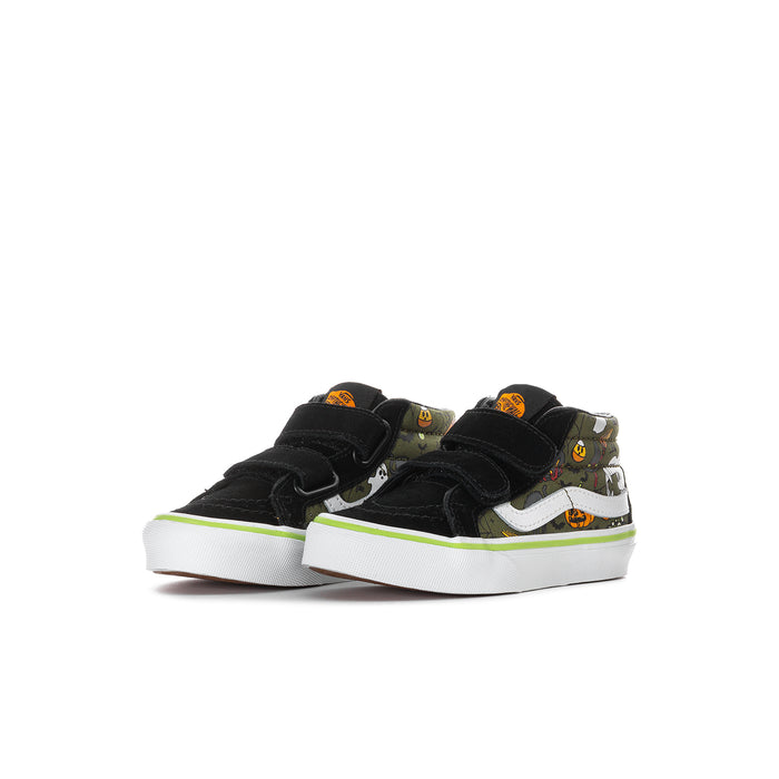 Kids mid-top sneakers side view, black canvas with green-and-white accents and Velcro closure.