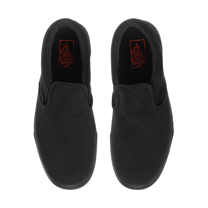 Black slip-on sneakers with inner red logo patch and smooth fabric uppers