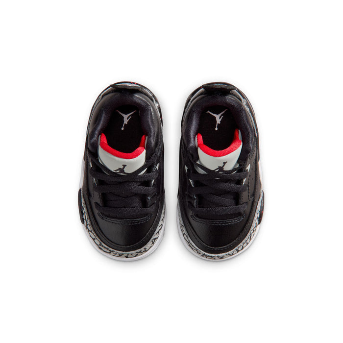 Toddler black sneakers with red accents and white Jordan logo on tongue.