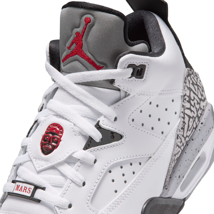 Youth sneakers close-up: white laces, red Jumpman on tongue, cement-gray speckled collar