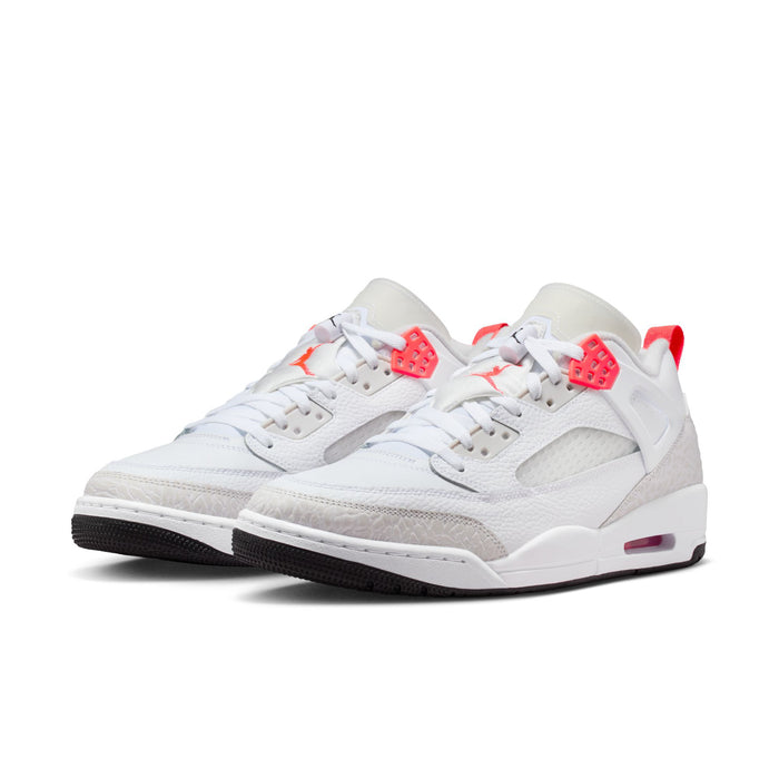 White low-top sneakers with red-orange heel tab and side panel, lace-up design
