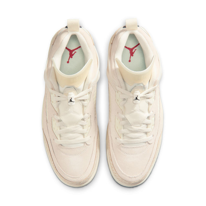 Pair of cream sneakers showing white laces and red logo on the inner lining
