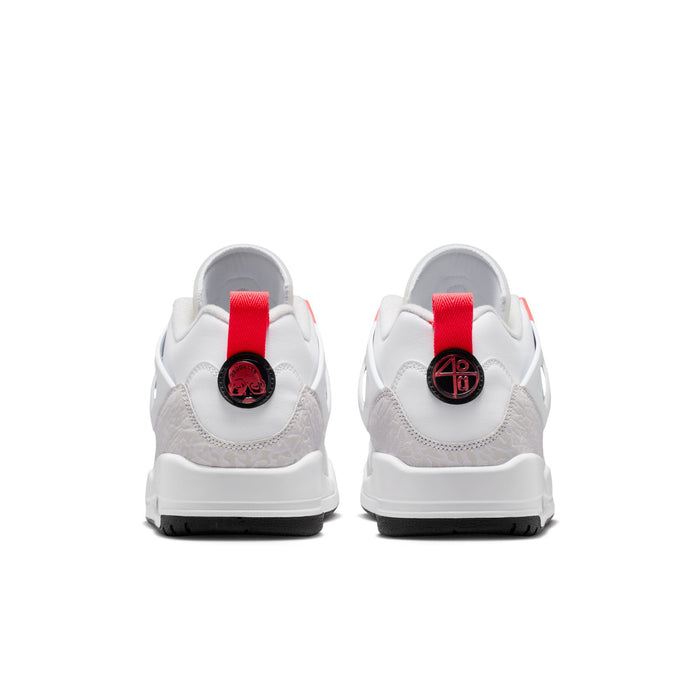 White low-top sneakers with red pull-tabs at the heel and logo embroidery