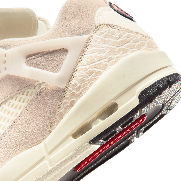 Close-up side of sail cream sneaker with textured panel and red/black midsole striping