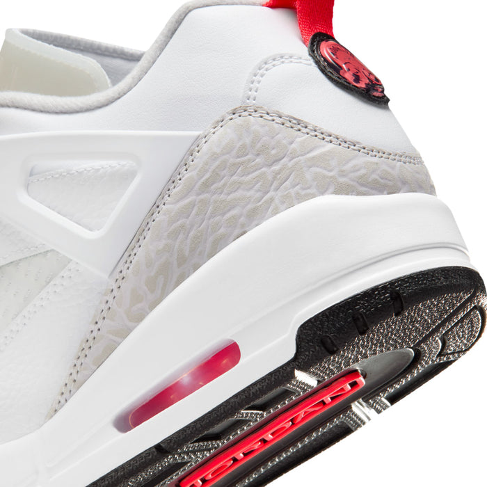 Close-up of white sneaker midsole with red air unit window and black outsole edge