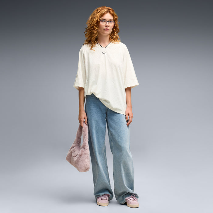 Women’s pink suede sneakers shown with blue jeans and casual outfit