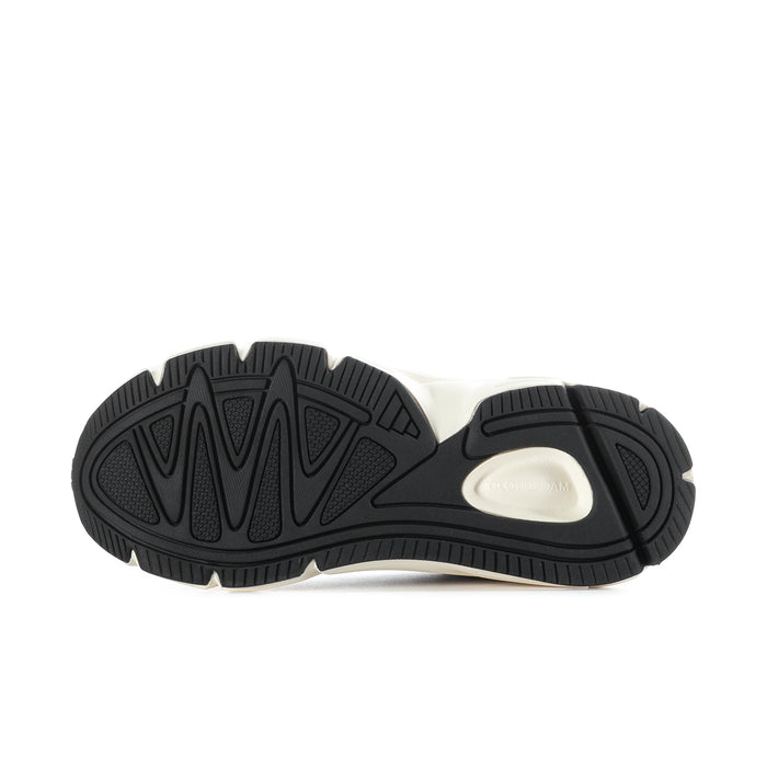 Women’s shoe outsole view with black tread and light midsole section