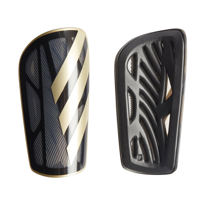 Black shin guard with metallic gold stripe and white accent, vented shell