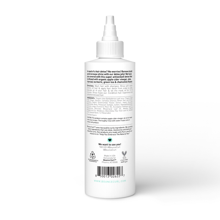 Bounce Curl styling product in a white nozzle bottle, centered on a soft beige background