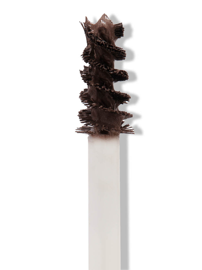 black -- close up of unibrow tinted brow gel brush on white background