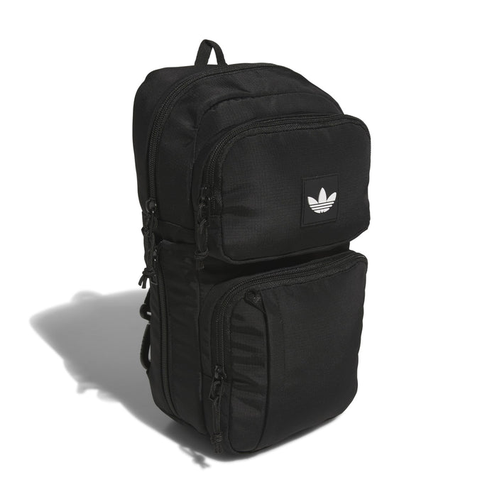Black utility sling bag with front zip pockets and small logo patch
