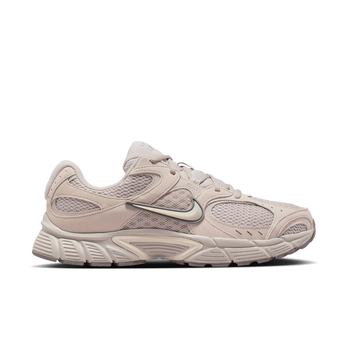 Men's beige Nike lace-up running shoes with mesh panels and chunky sole.
