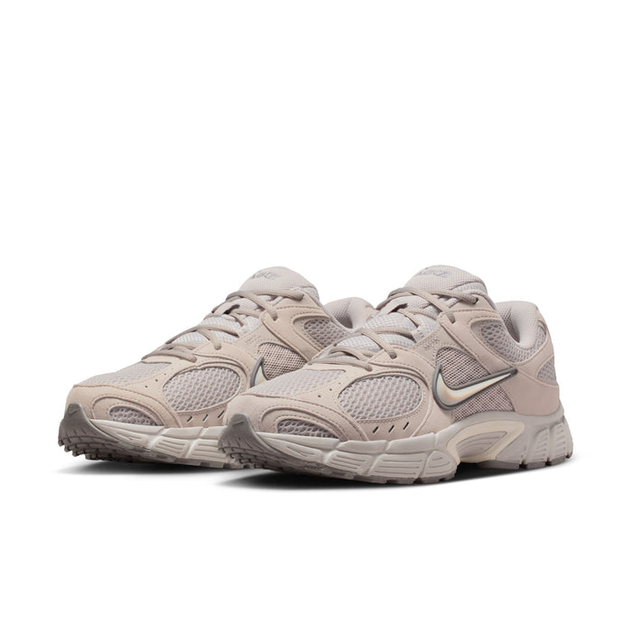 Men's beige Nike lace-up running shoes with two-tone overlays and chunky midsole.
