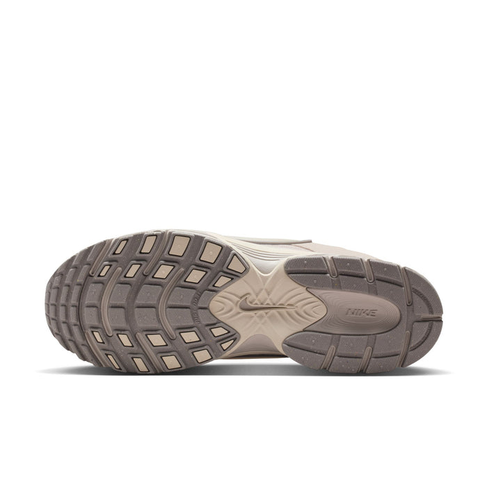Men's beige Nike running shoes outsole with multidirectional tread and traction pods.