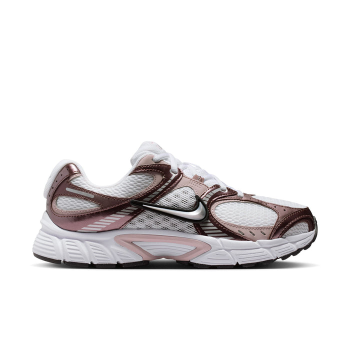 Women’s running sneakers in white, rose, and brown with black Nike swoosh detail