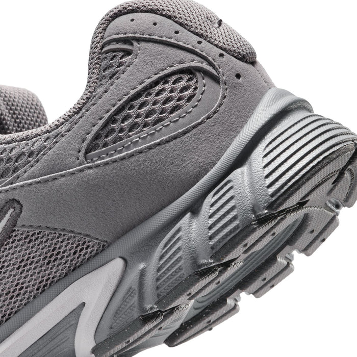 Close-up of youth dark gray sneaker side with mesh texture and striped midsole graphics