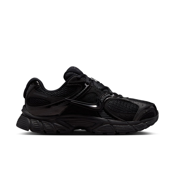 Black womens wide athletic sneaker with mesh panels and Nike Swoosh, lace-up.