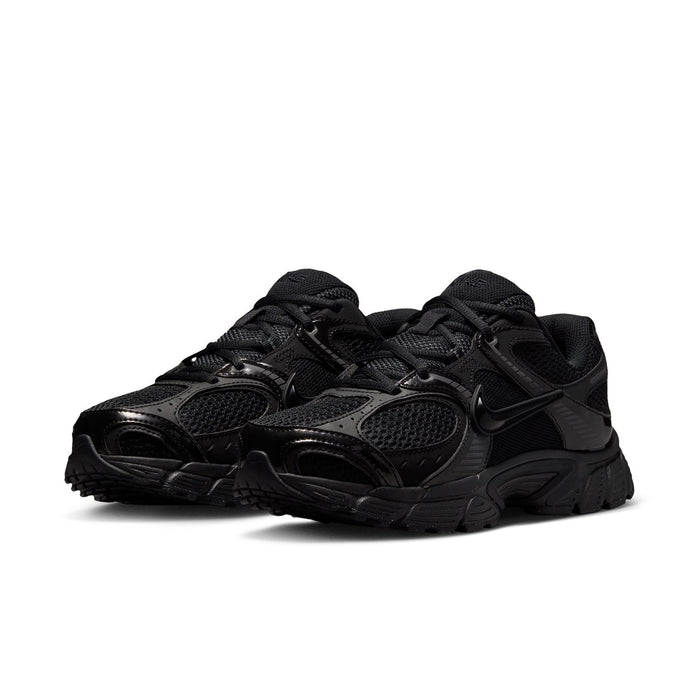 Black womens wide athletic sneaker, lace-up design, textured upper, Nike Swoosh visible.