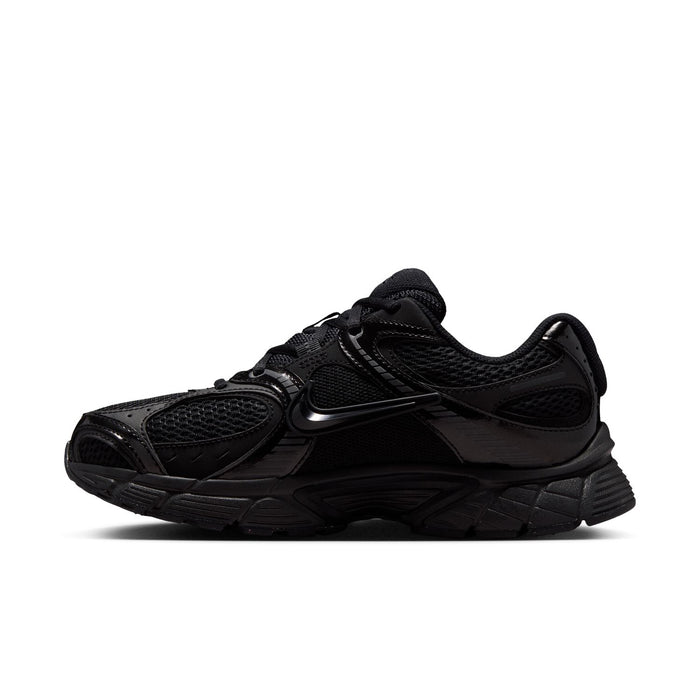 Black womens wide athletic sneaker side view with lace-up and layered synthetic panels.