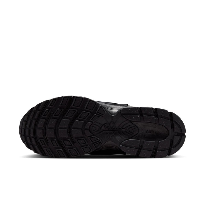 Black sneaker outsole with traction tread lugs and textured rubber base.