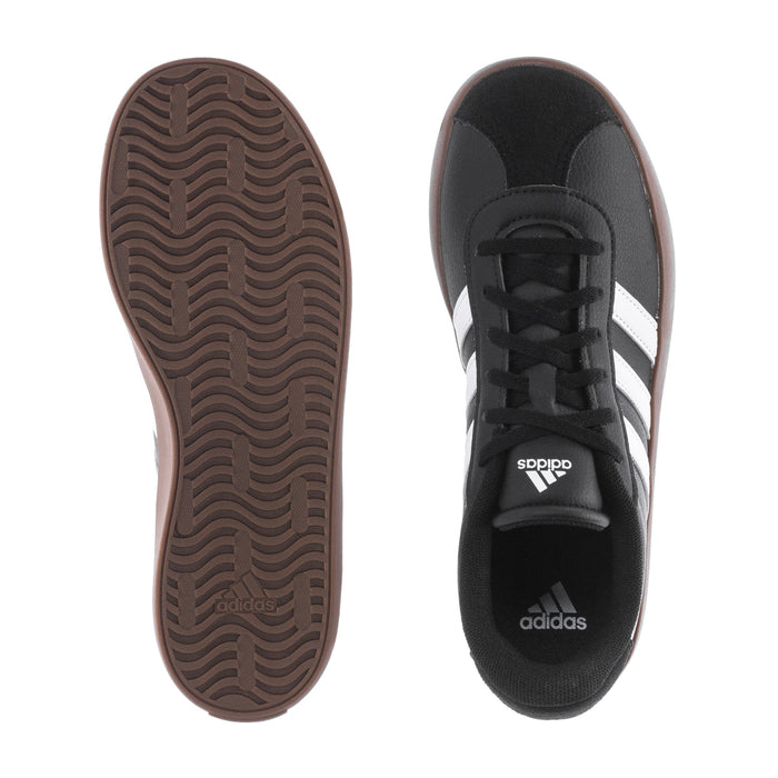 Black youth sneaker sole with tread, adidas tongue logo, white stripe detail