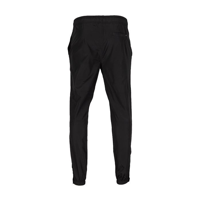 Black wind pants back view with elastic waistband and tapered legs