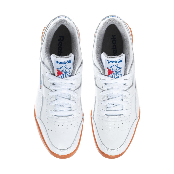 Pair of white Reebok sneakers with orange-trimmed outsole and blue tongue logo