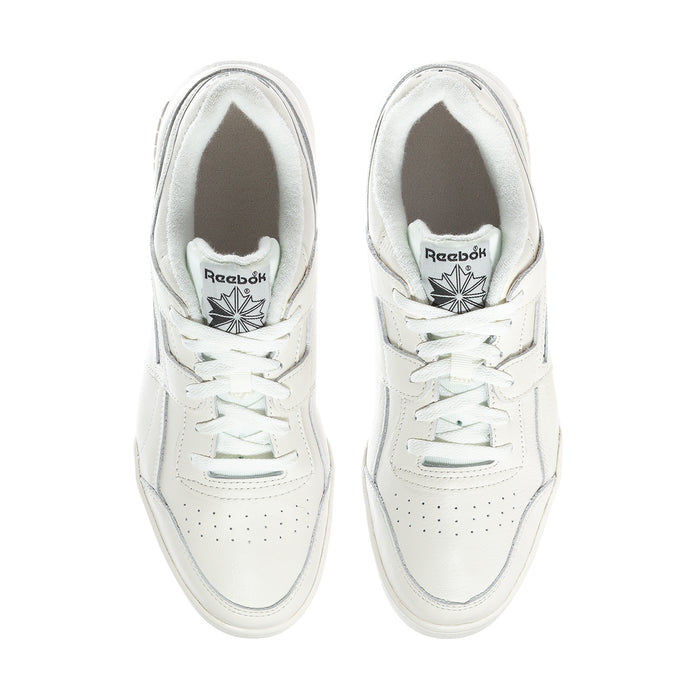 White lace-up sneakers with Reebok emblem on tongue and perforated toe.