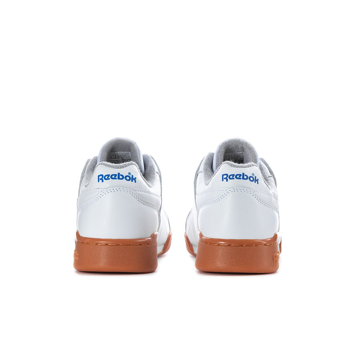 Rear view of white Reebok sneakers with tan heel tab and blue logo