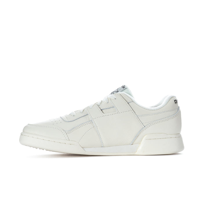 White low-top lace-up sneakers with side seam stripes and Reebok logo.