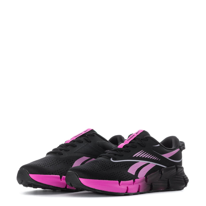 Youth black and pink sneakers in angled side view, lace-up with patterned upper