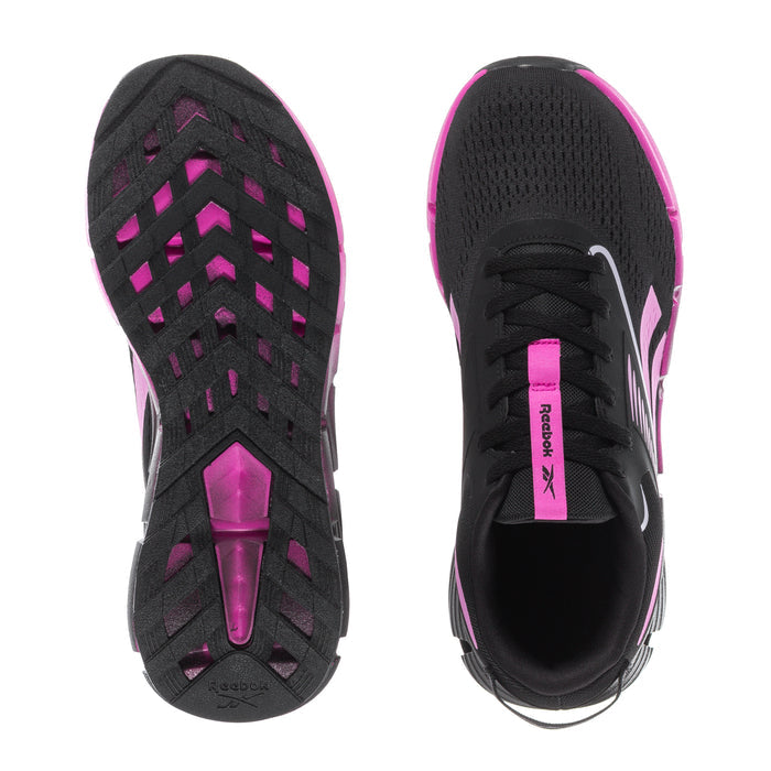 Youth black sneakers with pink zigzag accents and treaded rubber outsole